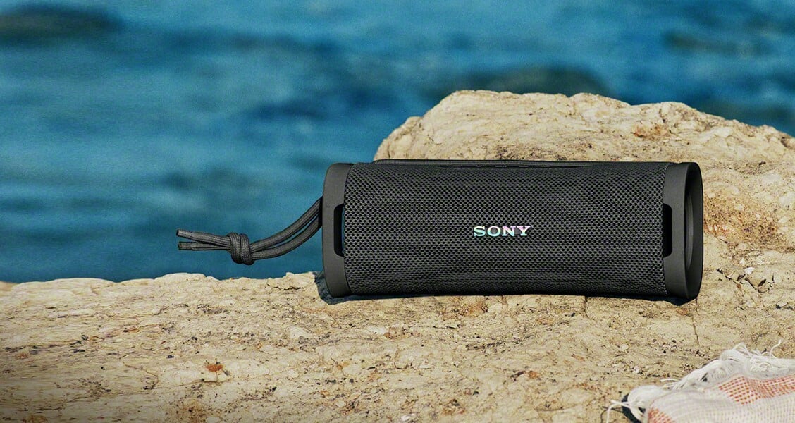 Sony ULT Field 1 speaker sits on a rock near the water