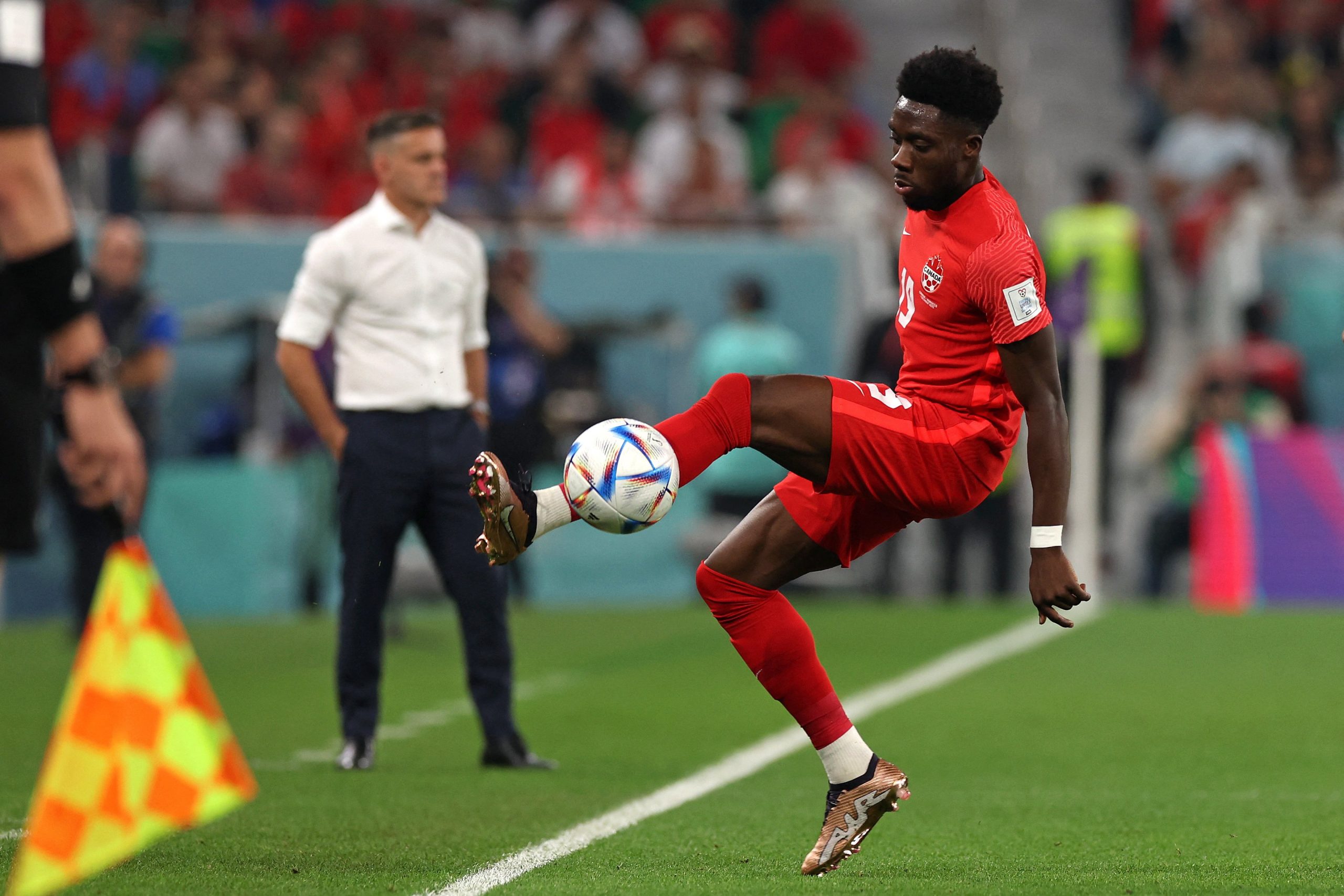 Alphonso Davies controls the ball 