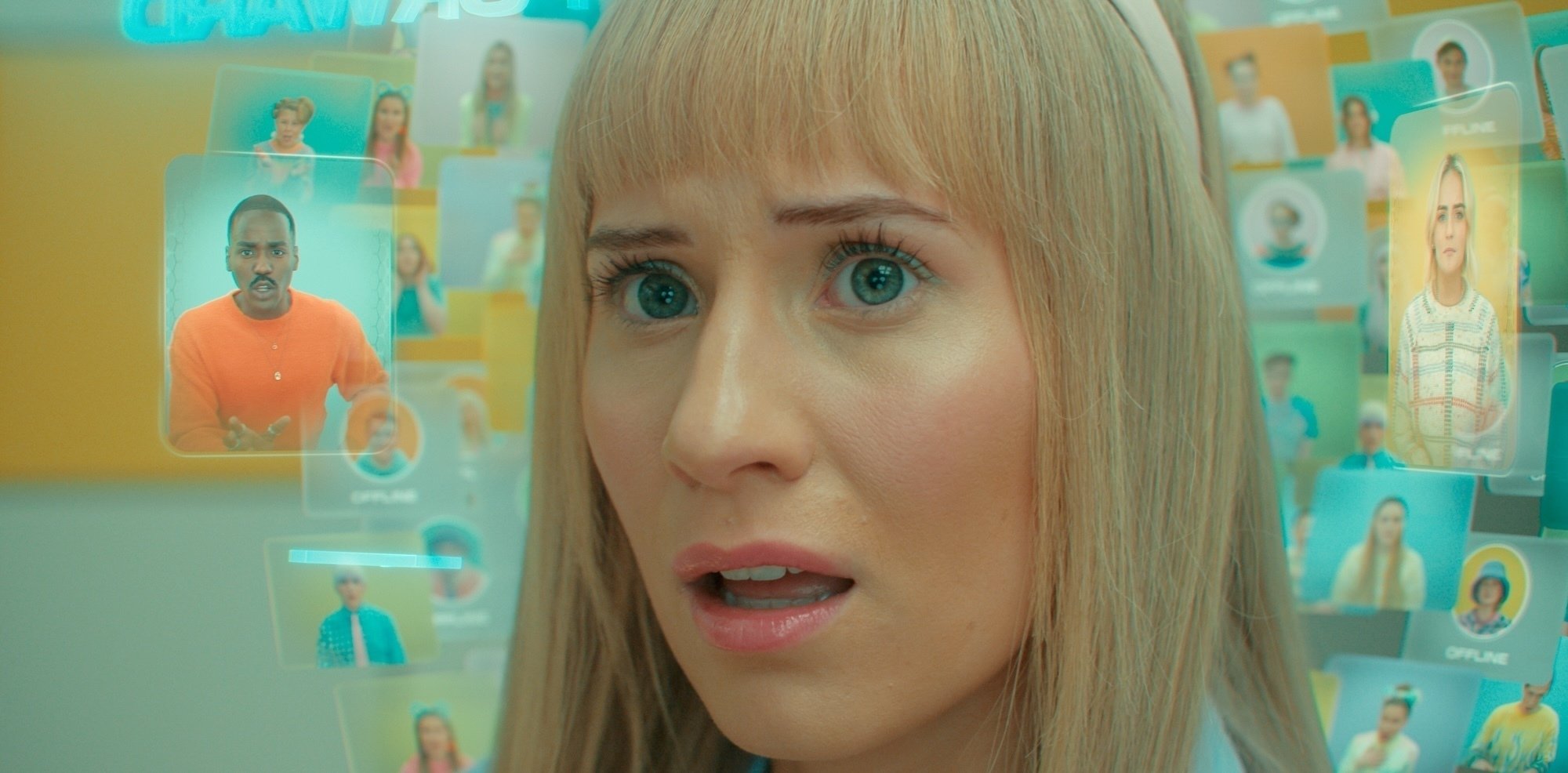 A blonde woman surrounded by virtual images of friends and the Doctor (Ncuti Gatwa).