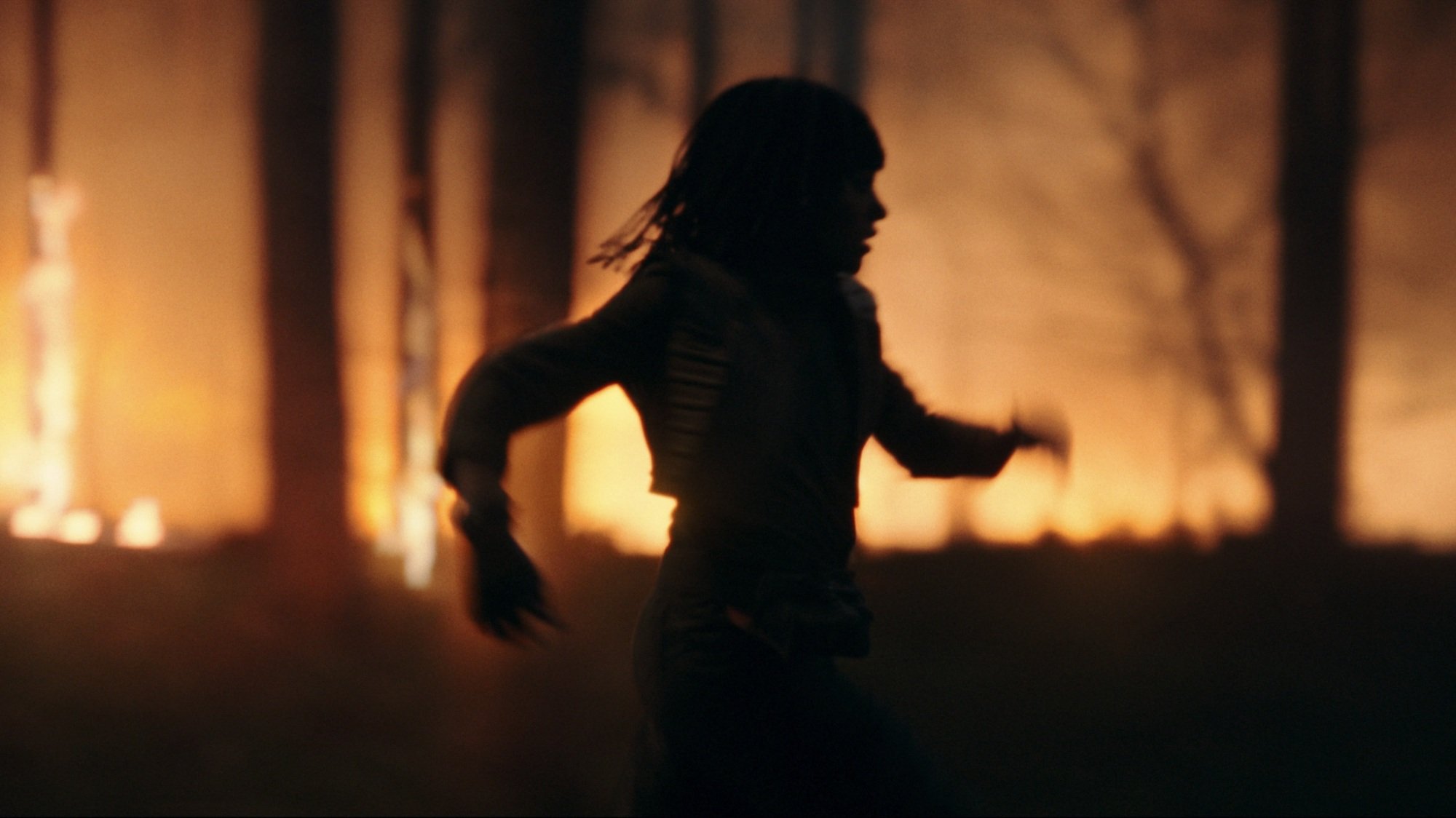 Osha Aniseya from "The Acolyte" runs through burning woods.