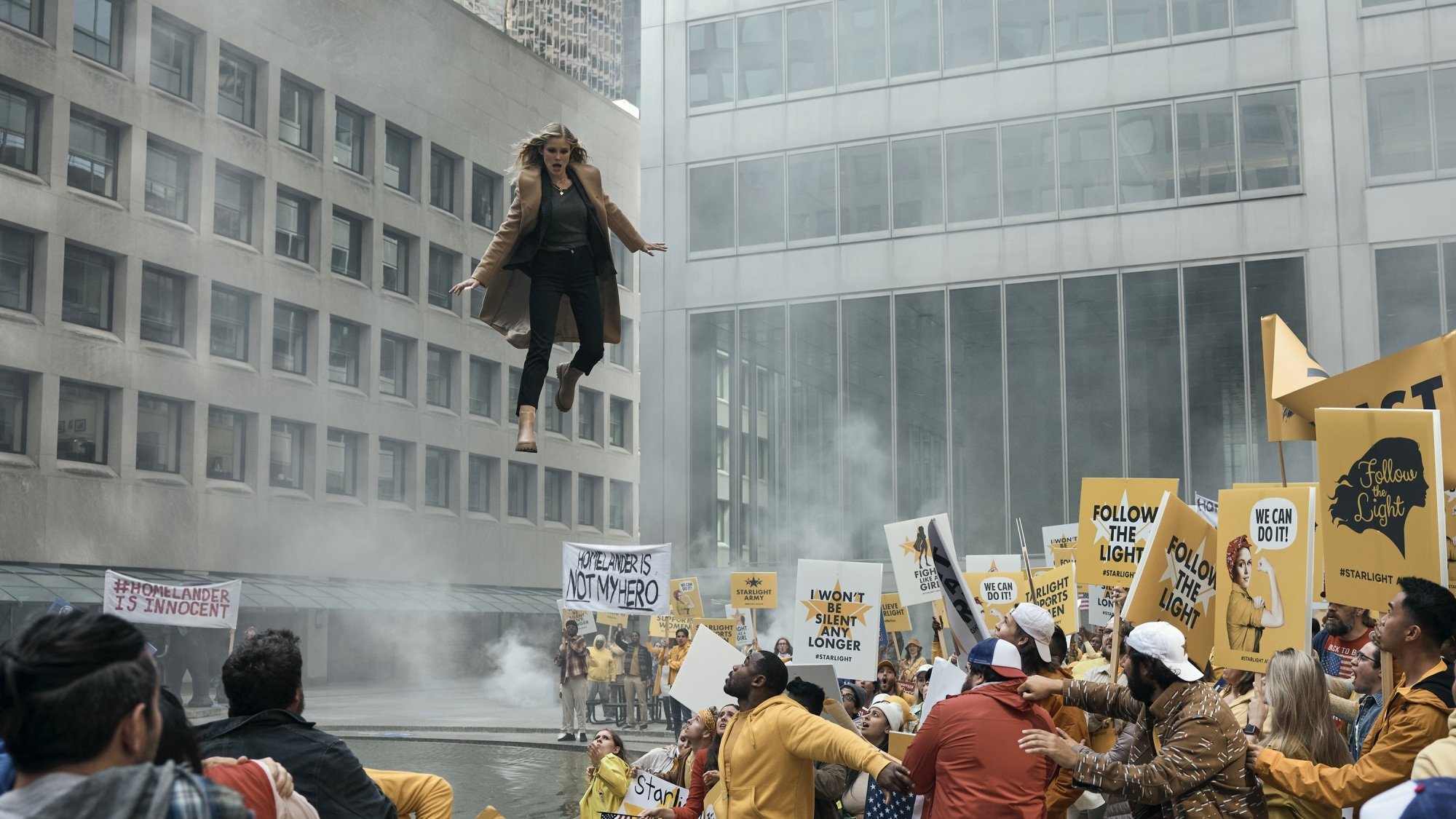 Annie January/Starlight flies into an agitated crowd of protestors in yellow shirt.