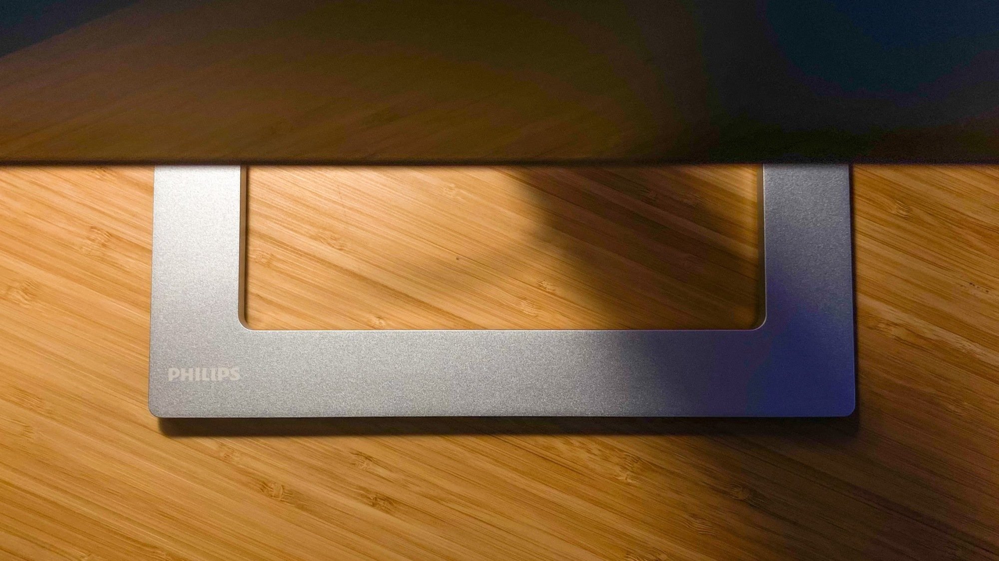 philips creator series 4k monitor base on wood desk