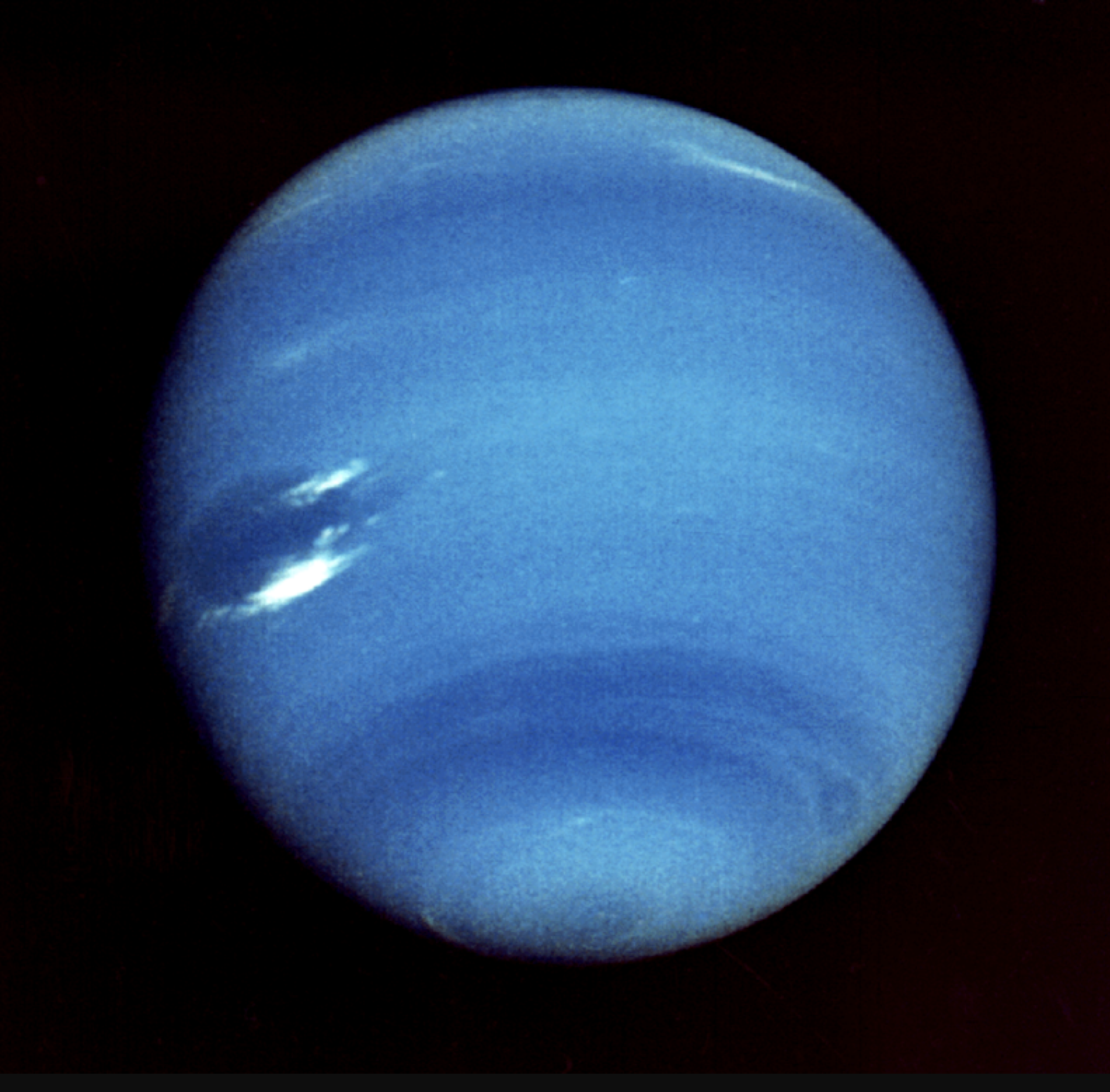 A view of Neptune from Voyager 2, taken in 1989. Strong wind bands are seen swirling across the atmosphere.