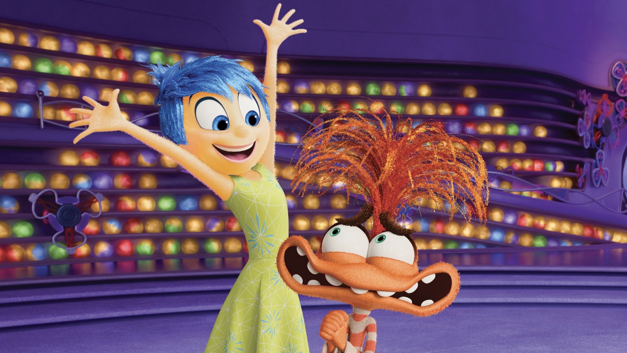 Joy from "Inside Out 2" throws her hands up and smiles next to a worried-looking Anxiety.