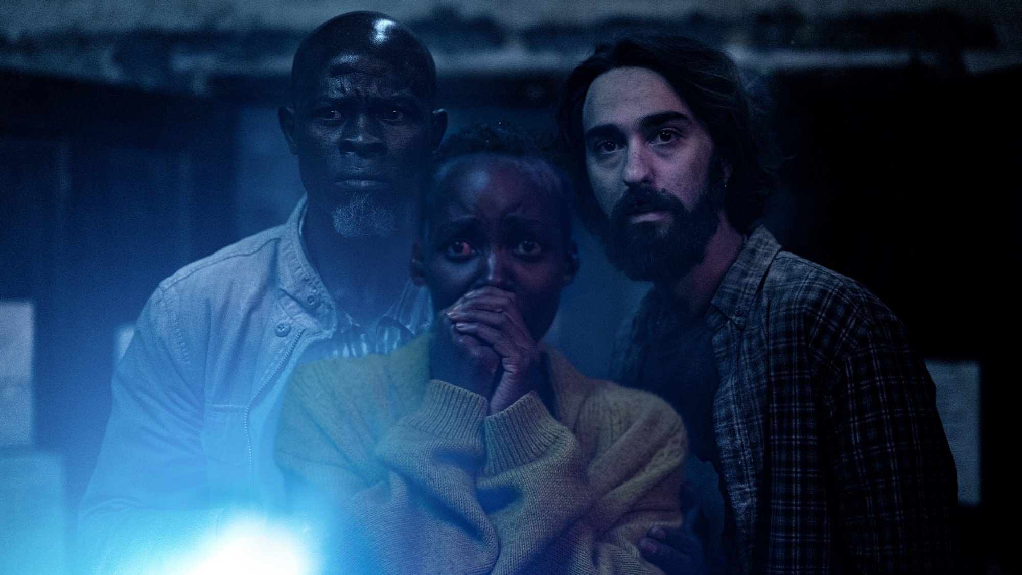 Alex Wolff, Djimon Hounsou, and Lupita Nyong'o look scared in "A Quiet Place: Day One."