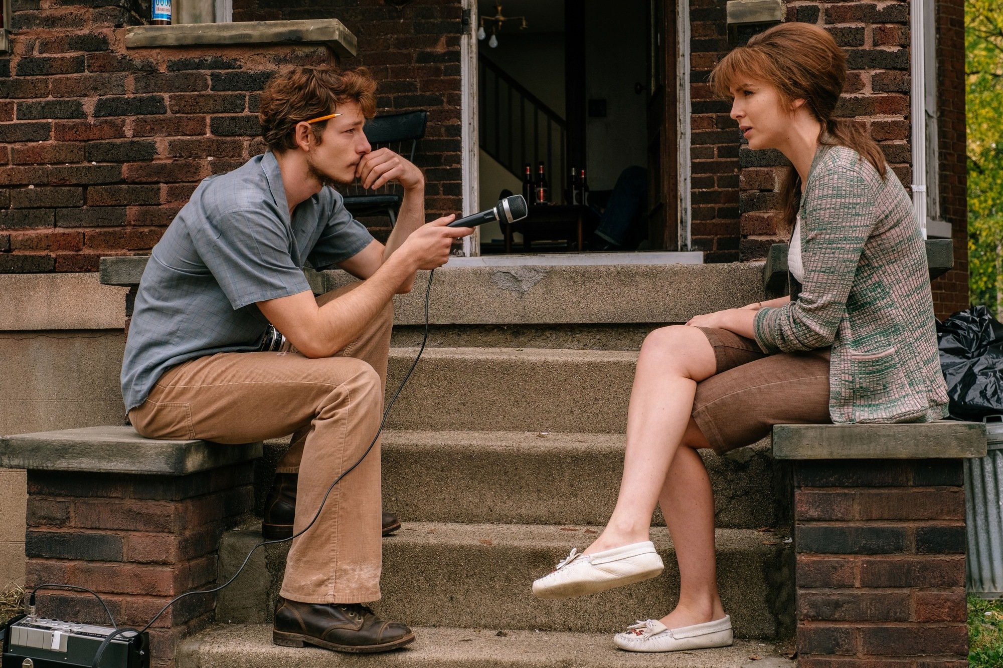 Jodie Comer is interviewed by Mike Faist in "The Bikeriders." 