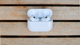 airpods pro in their case on wooden table