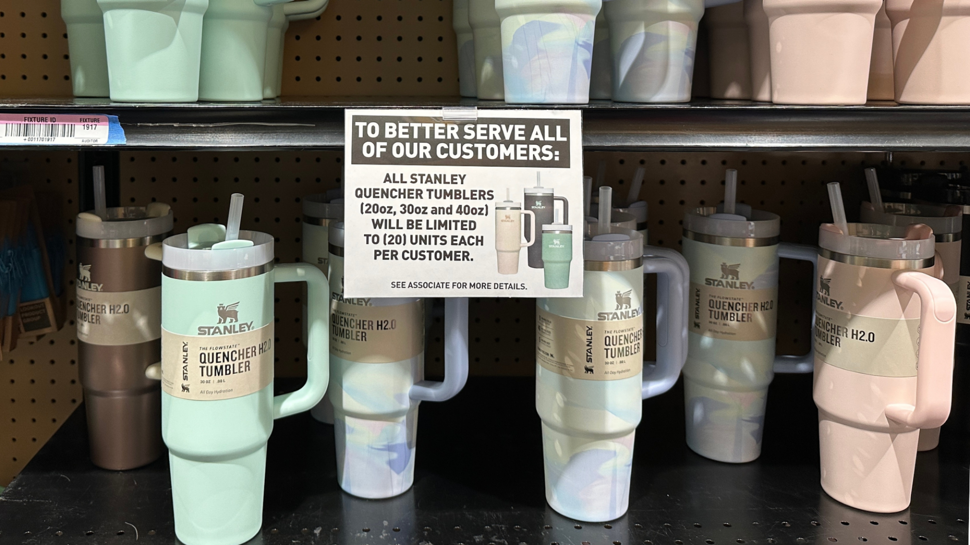 A shelf of Stanley tumblers in pastel colors.