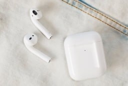 second generation airpods and case on denim 