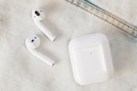 second generation airpods and case on denim 