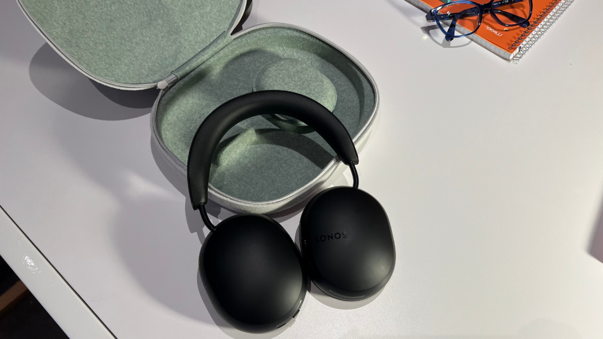 black sonos ace headphones resting on their carrying case