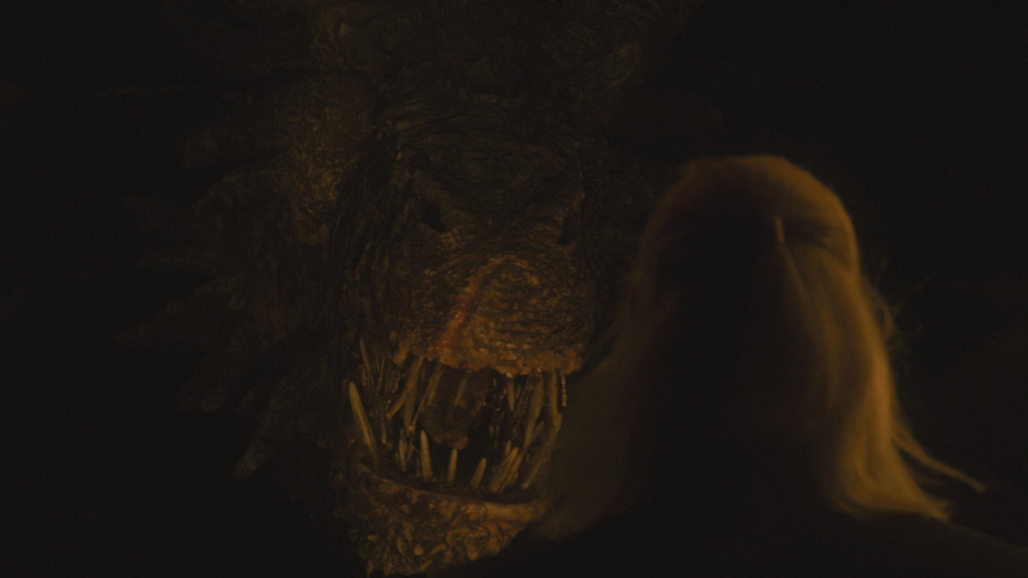 A dragon looms from the darkness in "House of the Dragon"