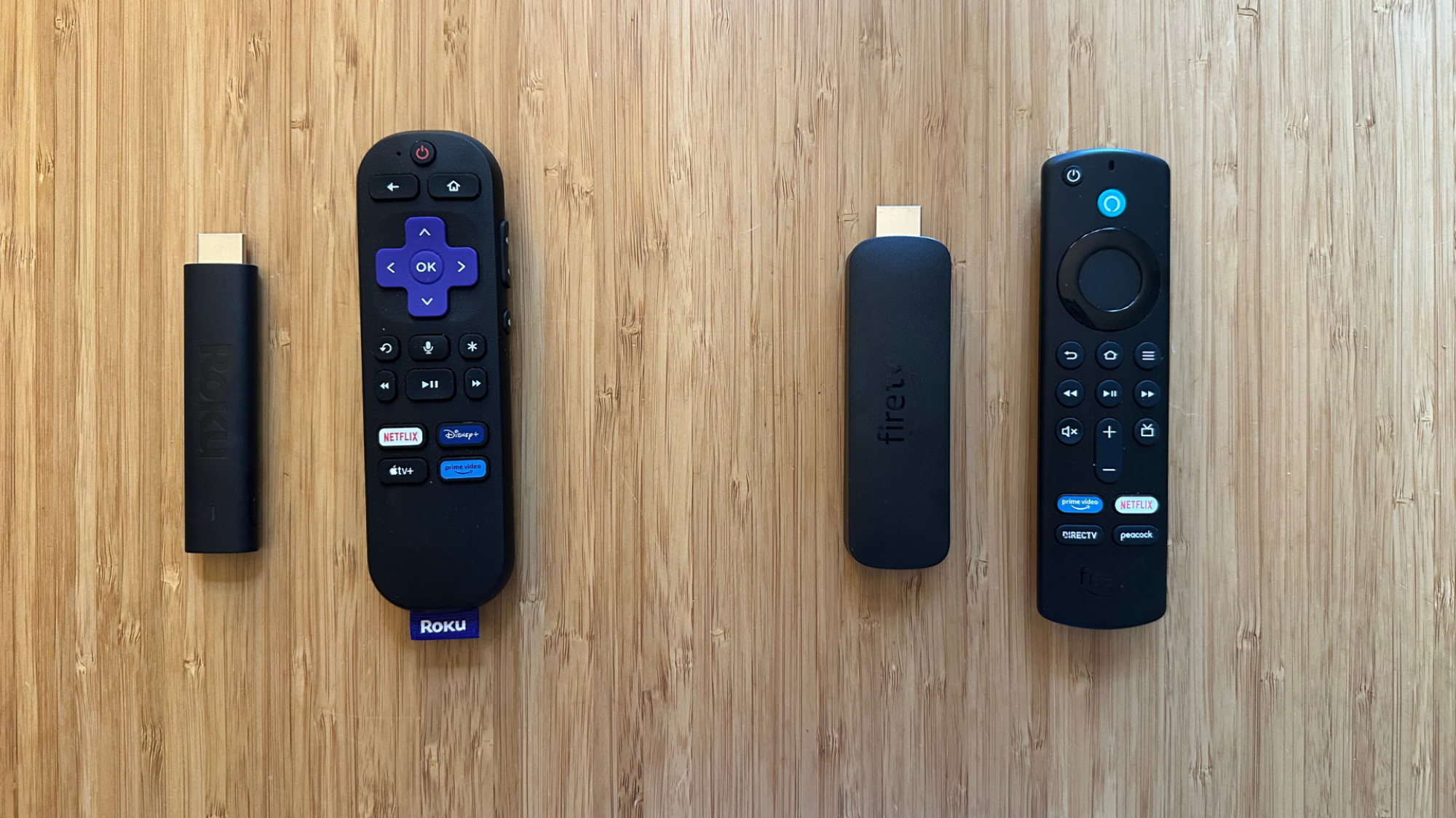 A side-by-side photo of the Roku and Amazon Fire TV Stick.