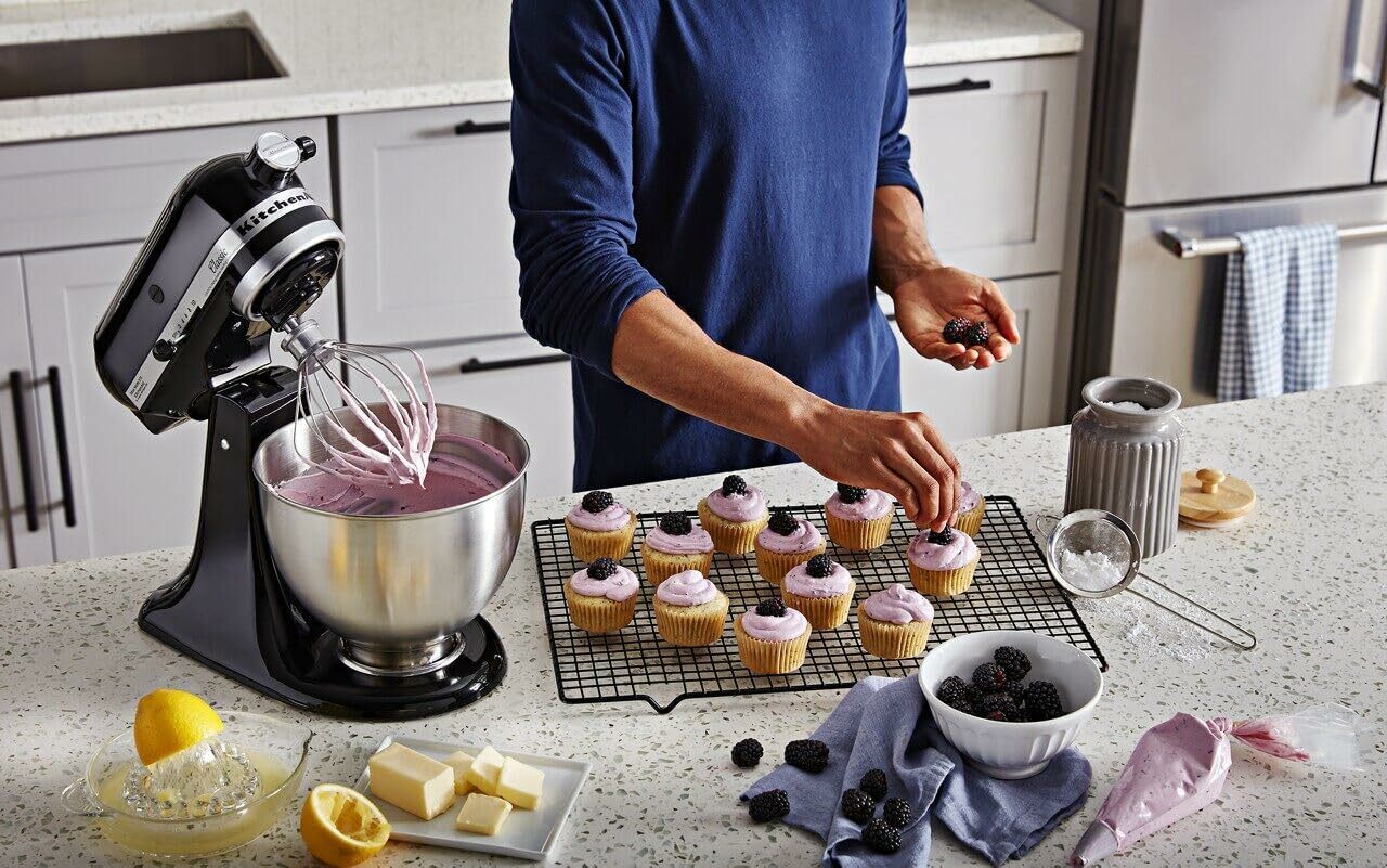 A person makes cupcakes with the KitchenAid mixer