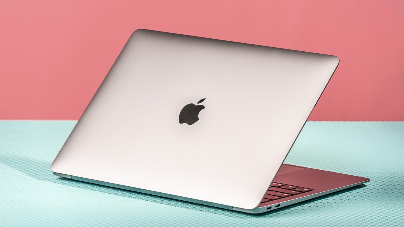 MacBook Air on pink and green background