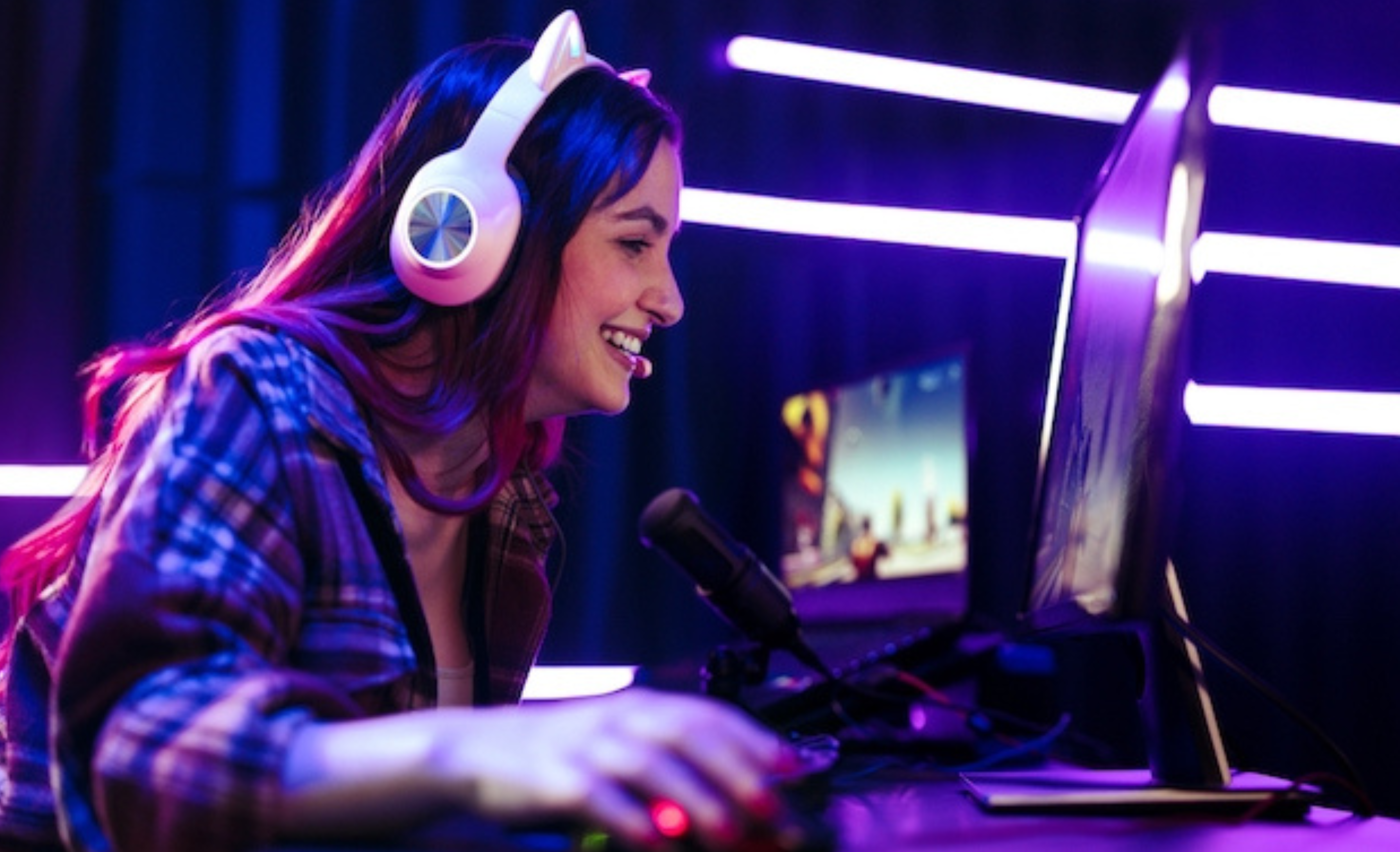 woman playing PC games in a purple room