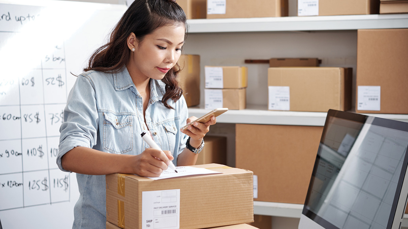 woman packaging boxes in warehouse