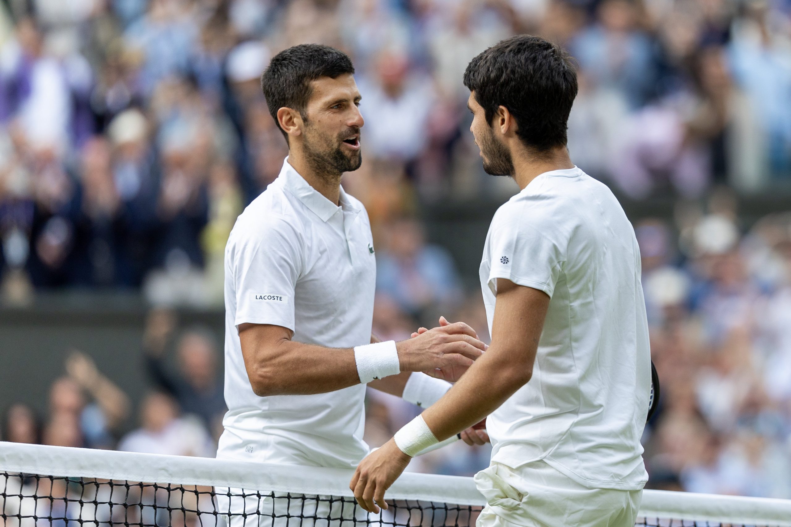 Djokovic and Alcaraz shake hands across the net