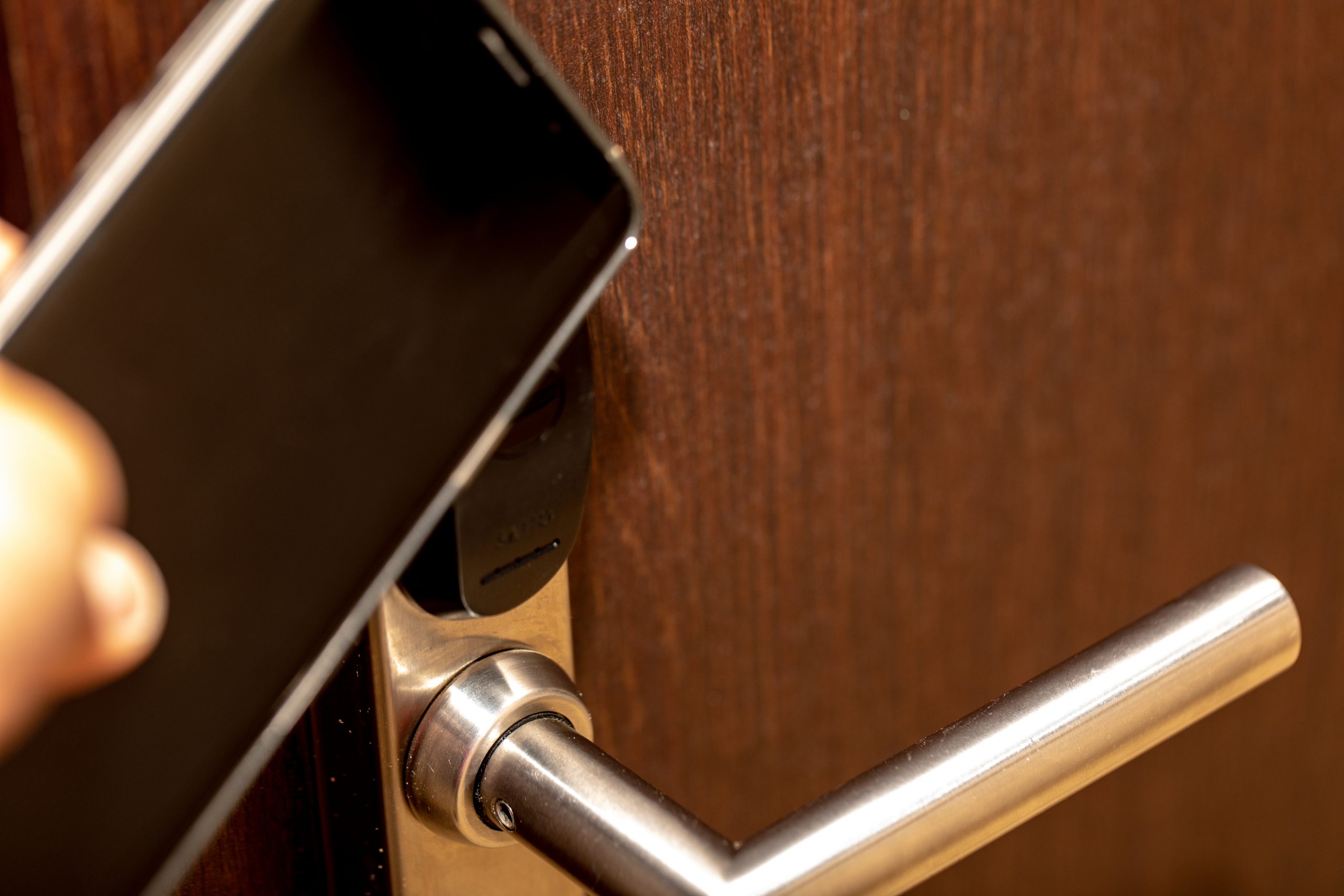 Phone being placed at doorknob for unlocking