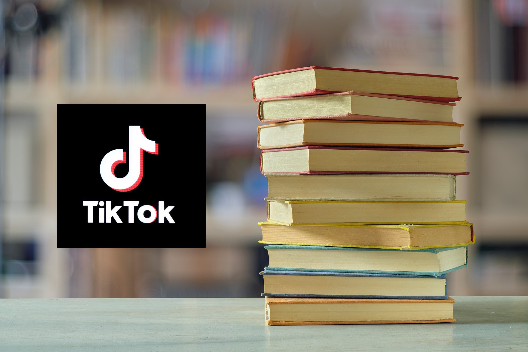 Stack of books next to the TikTok logo. 