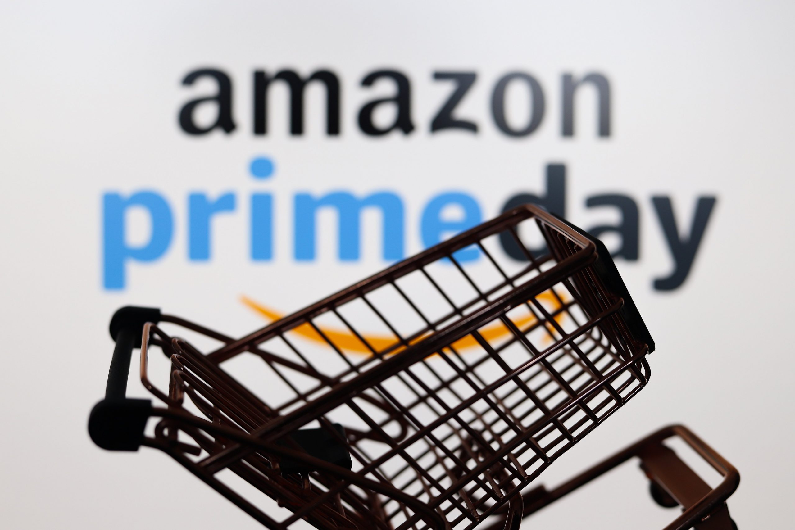 A shopping cart in front of a logo of Amazon Prime Day.