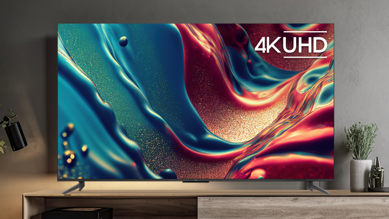 TCL 4K TV with colorful abstract liquid screensaver sitting on TV stand