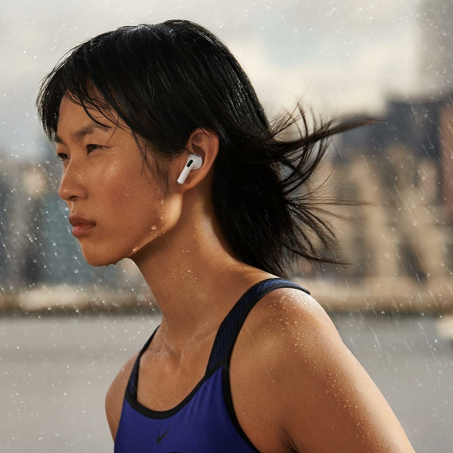 A woman jogging in Apple AirPods (third-gen).