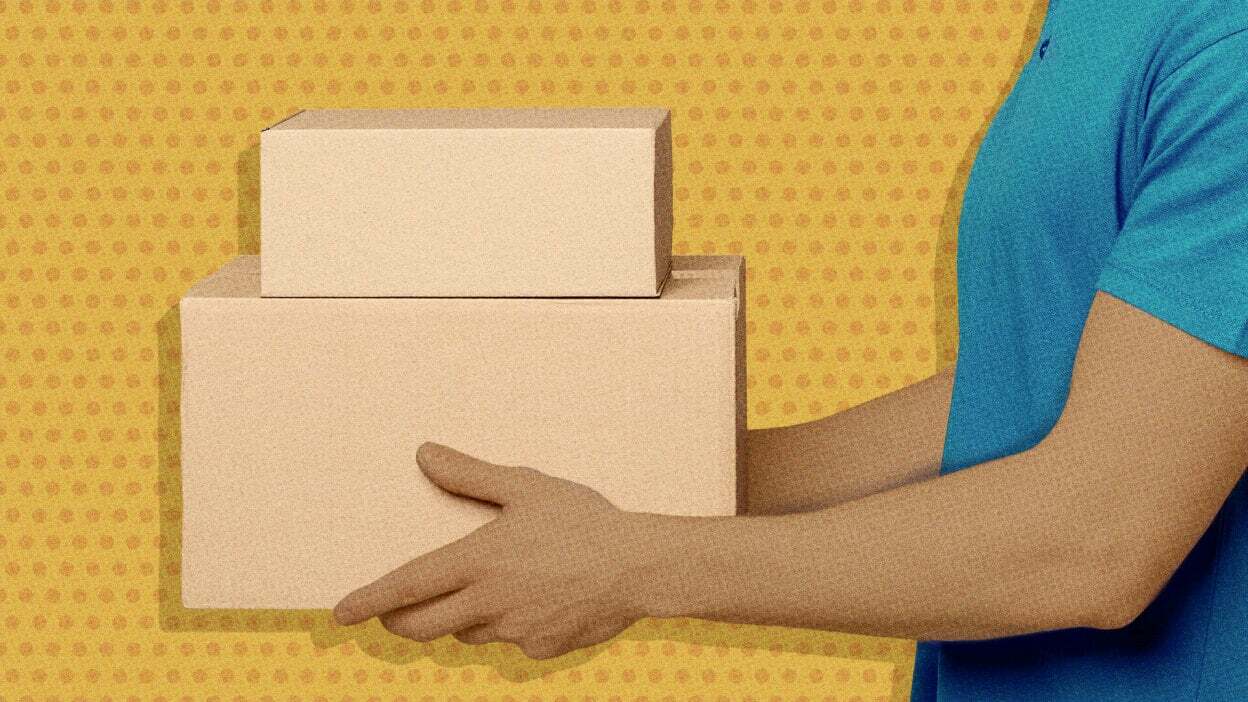 A person holding cardboard boxes.