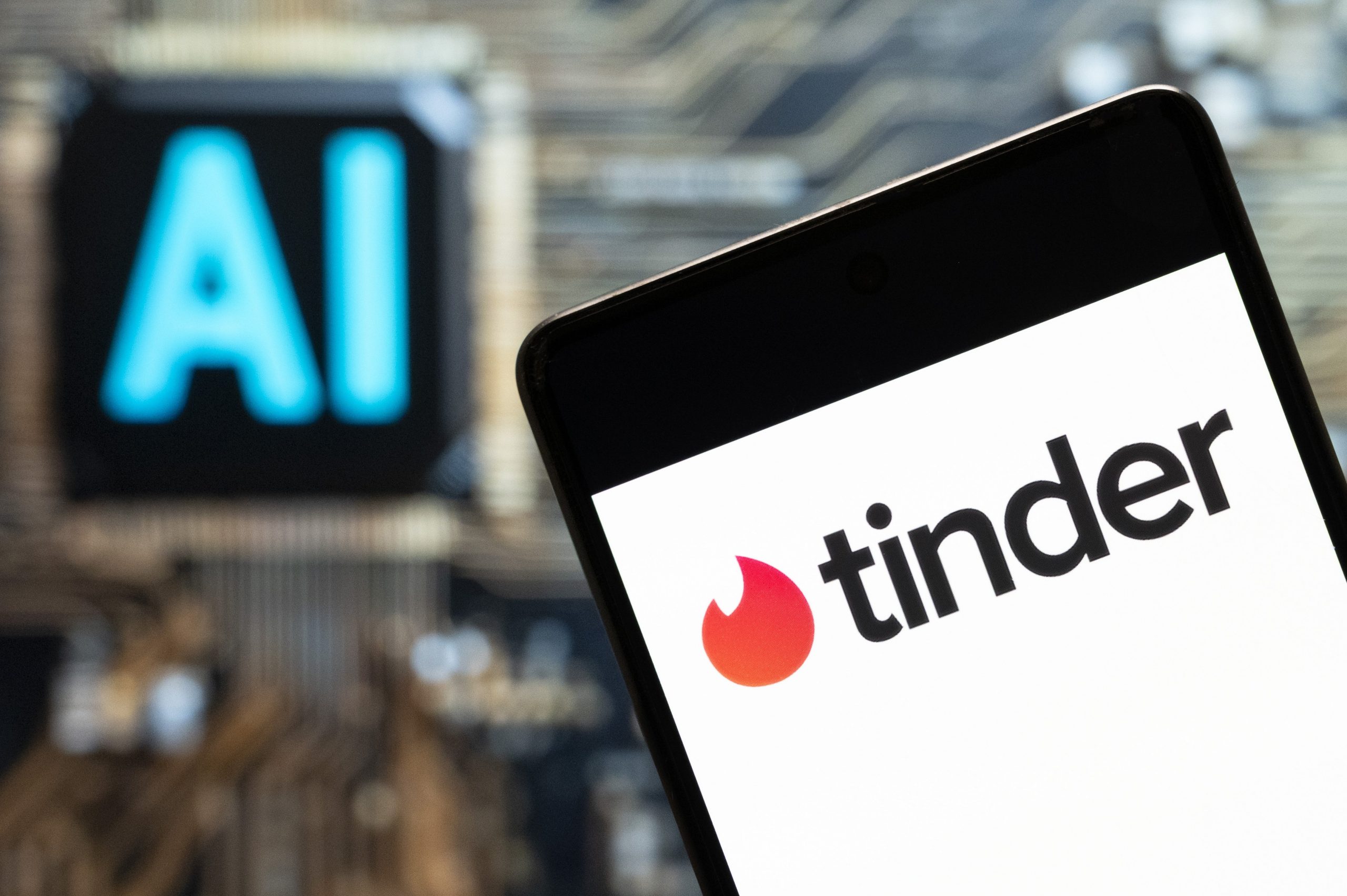 Tinder logo seen displayed on a smartphone with an Artificial intelligence (AI) chip and symbol in the background