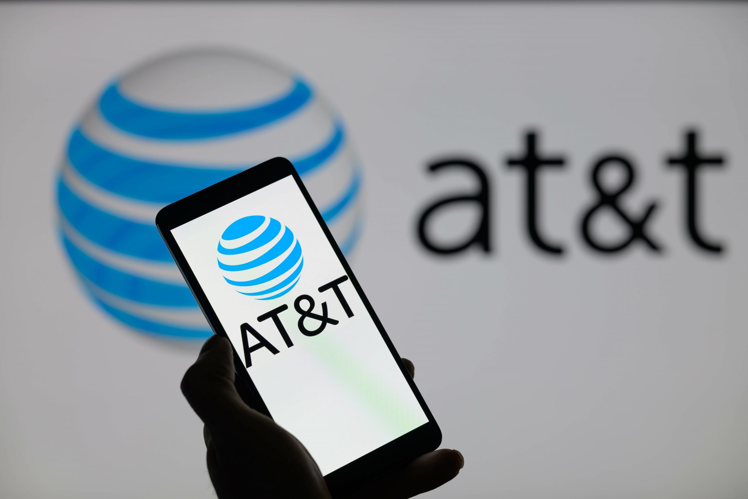 att logo on phone in front of att logo