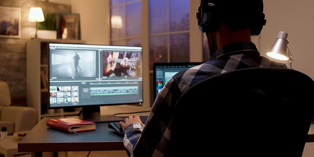 man editing video on his computer