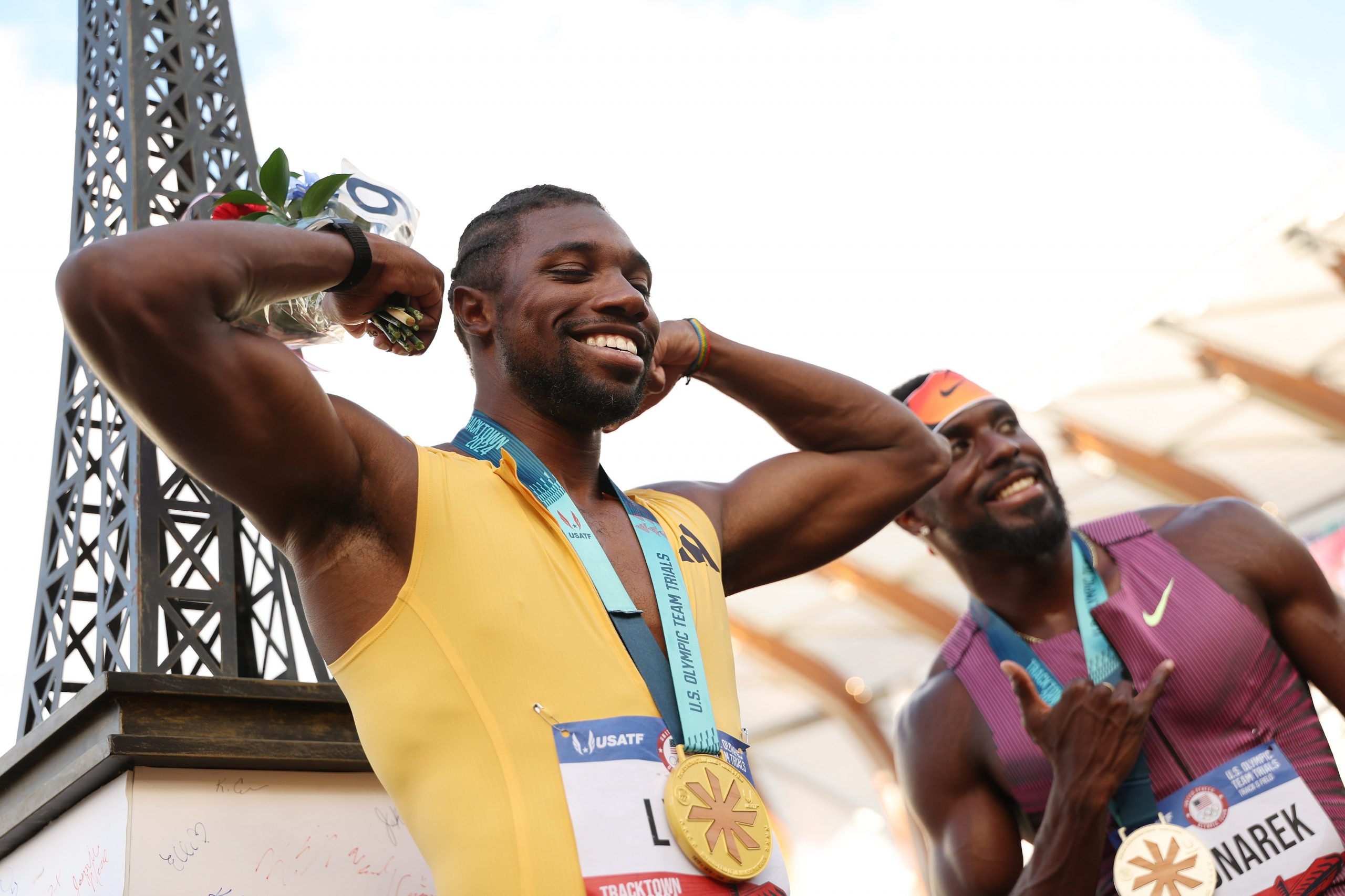  Gold medalist Noah Lyles poses with a miniature Eiffel Tower