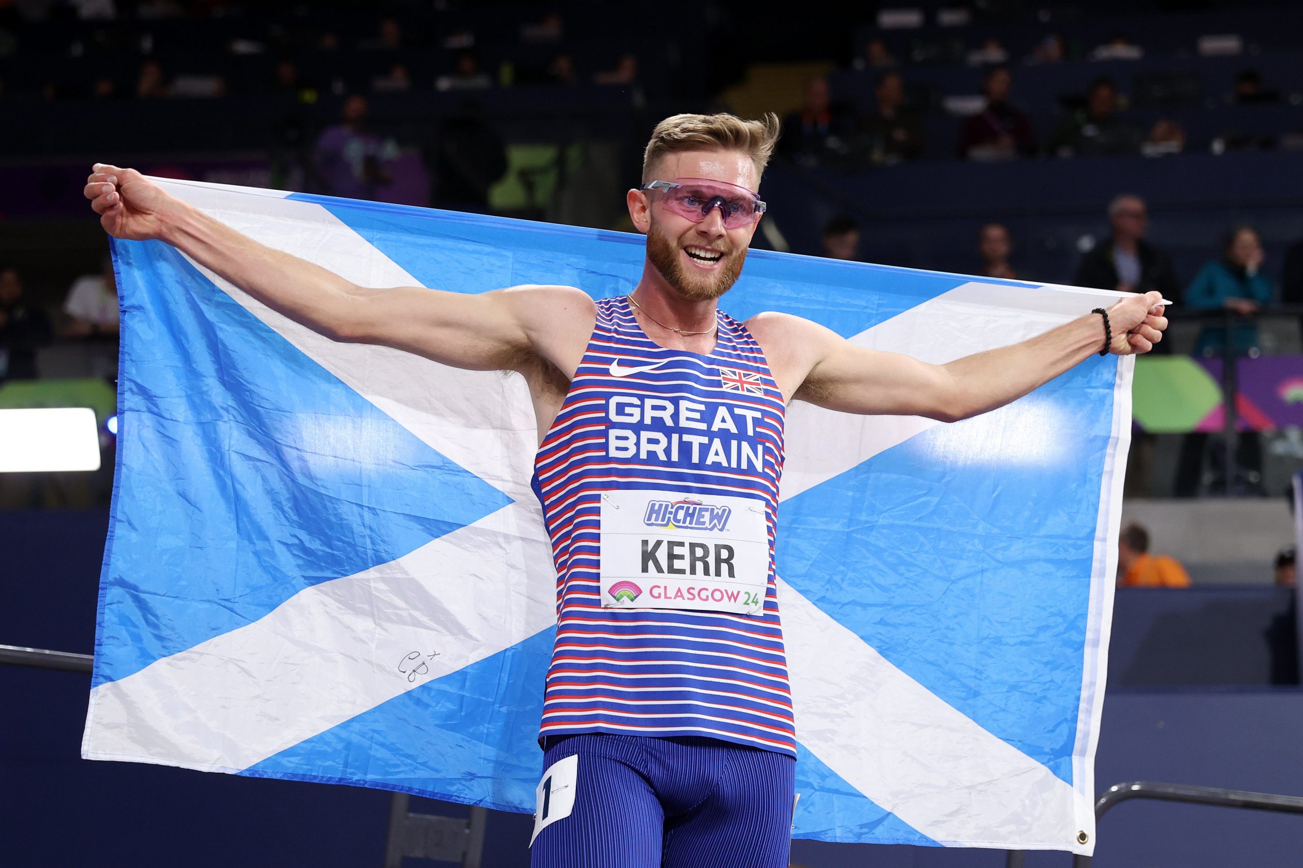 Josh Kerr holding Scottish flag at World Athletics Indoor Championships