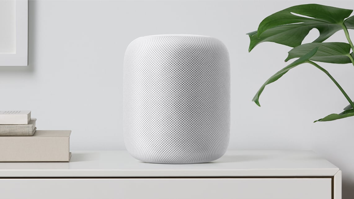 Apple HomePod sitting on a shelf.