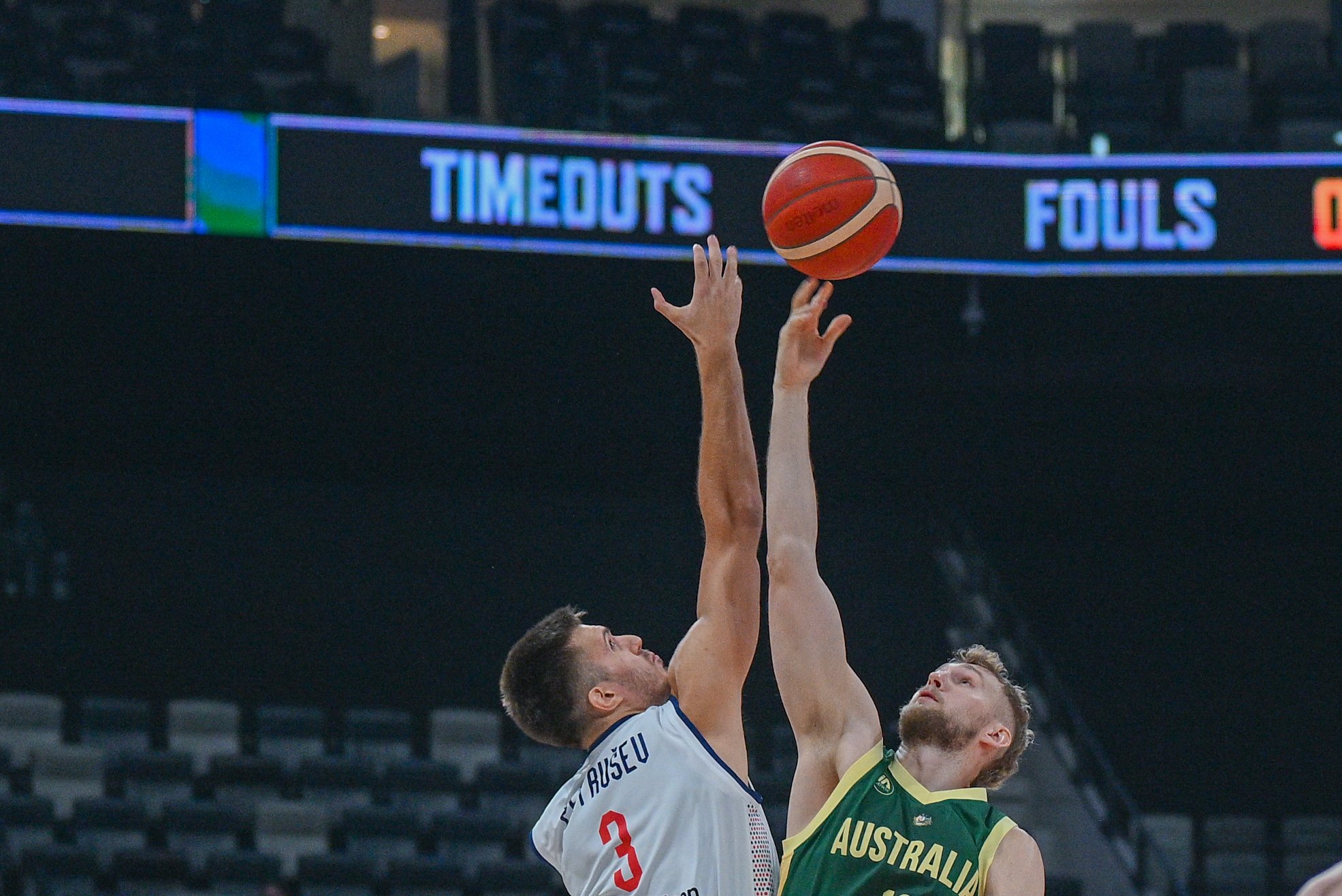 Australia and Serbia reach for the basketball