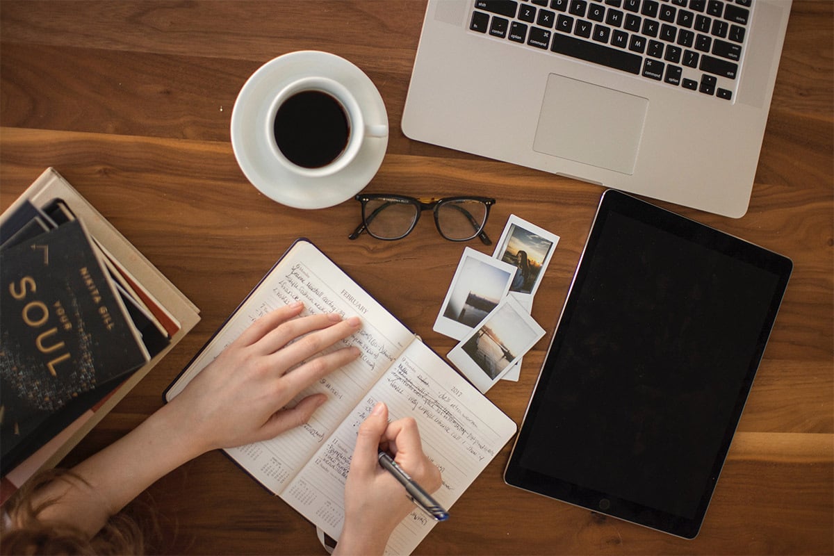 person writing in a notebook