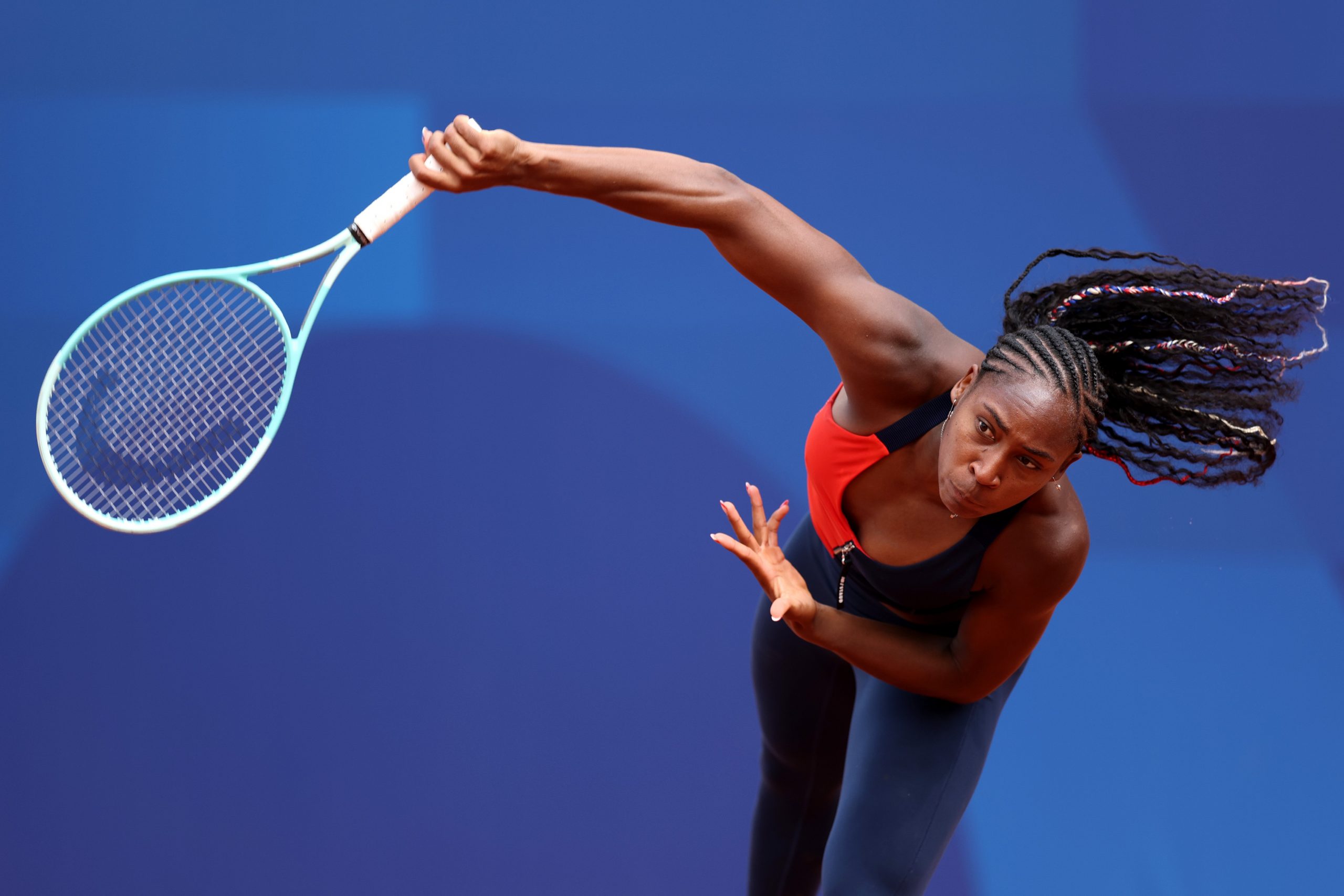 Coco Gauff serves at Paris 2024