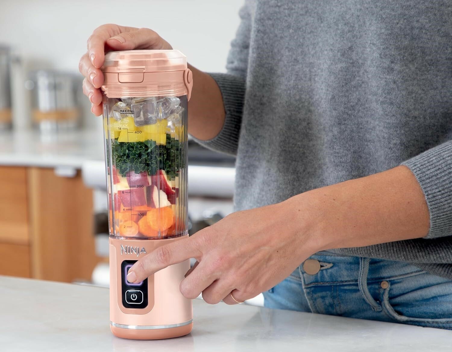 A woman uses the Nonja Portable Blender in the kitchen 