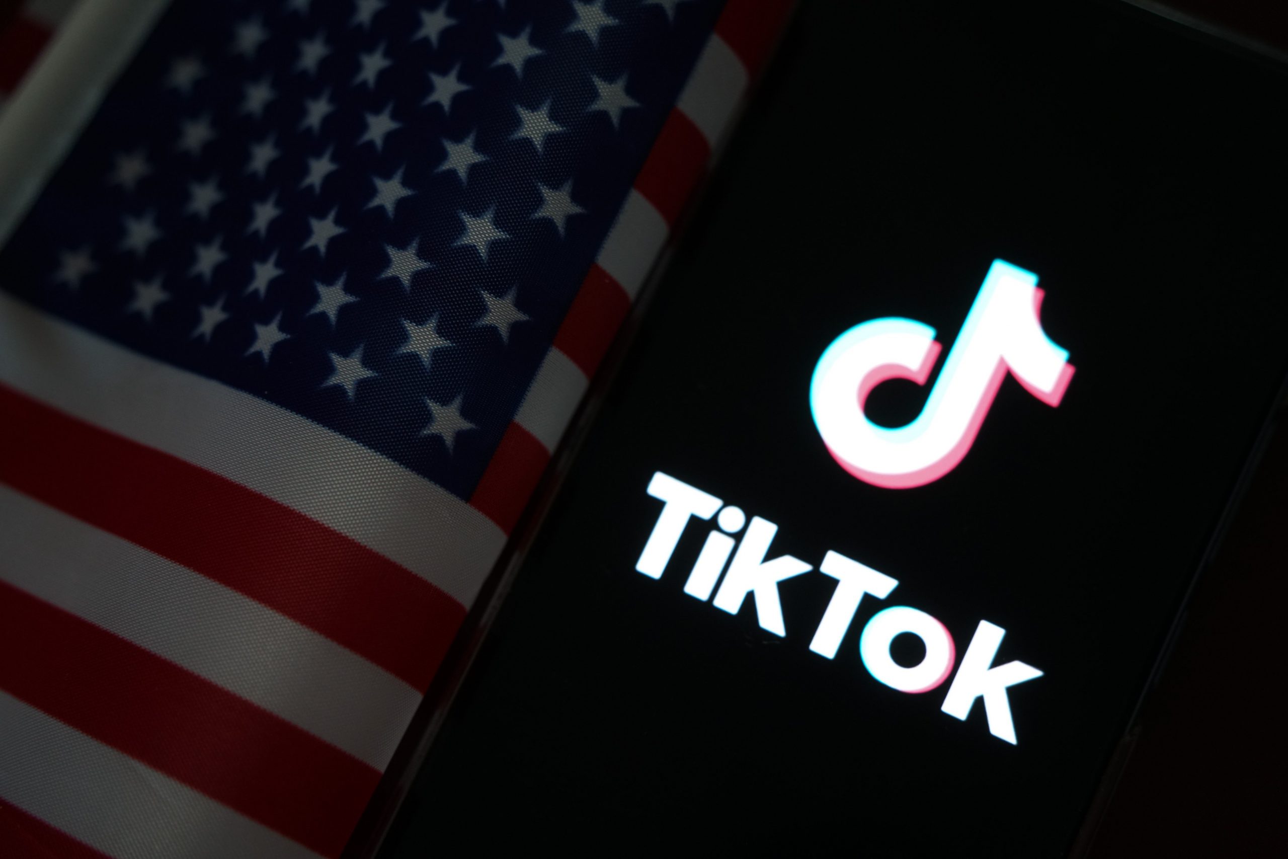 The TikTok logo next to an American flag.