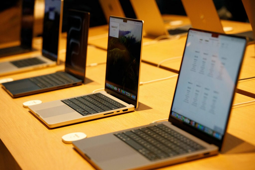 MacBooks in a row on display at a store