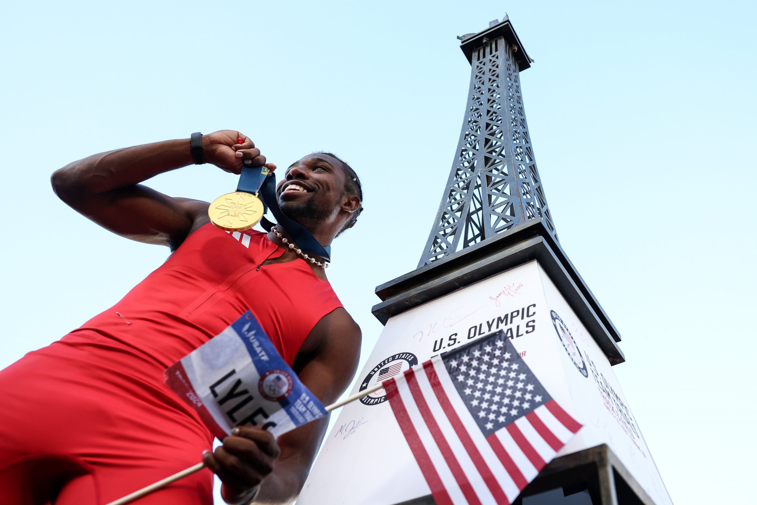 Noah Lyles celebrates with the gold medal