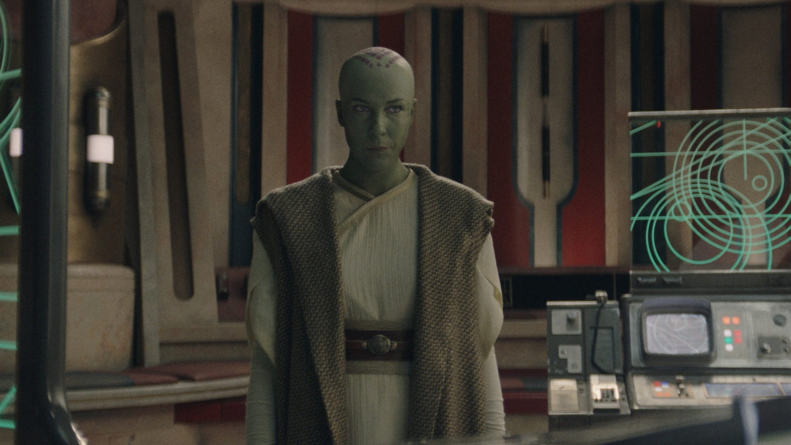 Vernestra Rwoh, a bald, green humanoid alien, in the Jedi Temple.