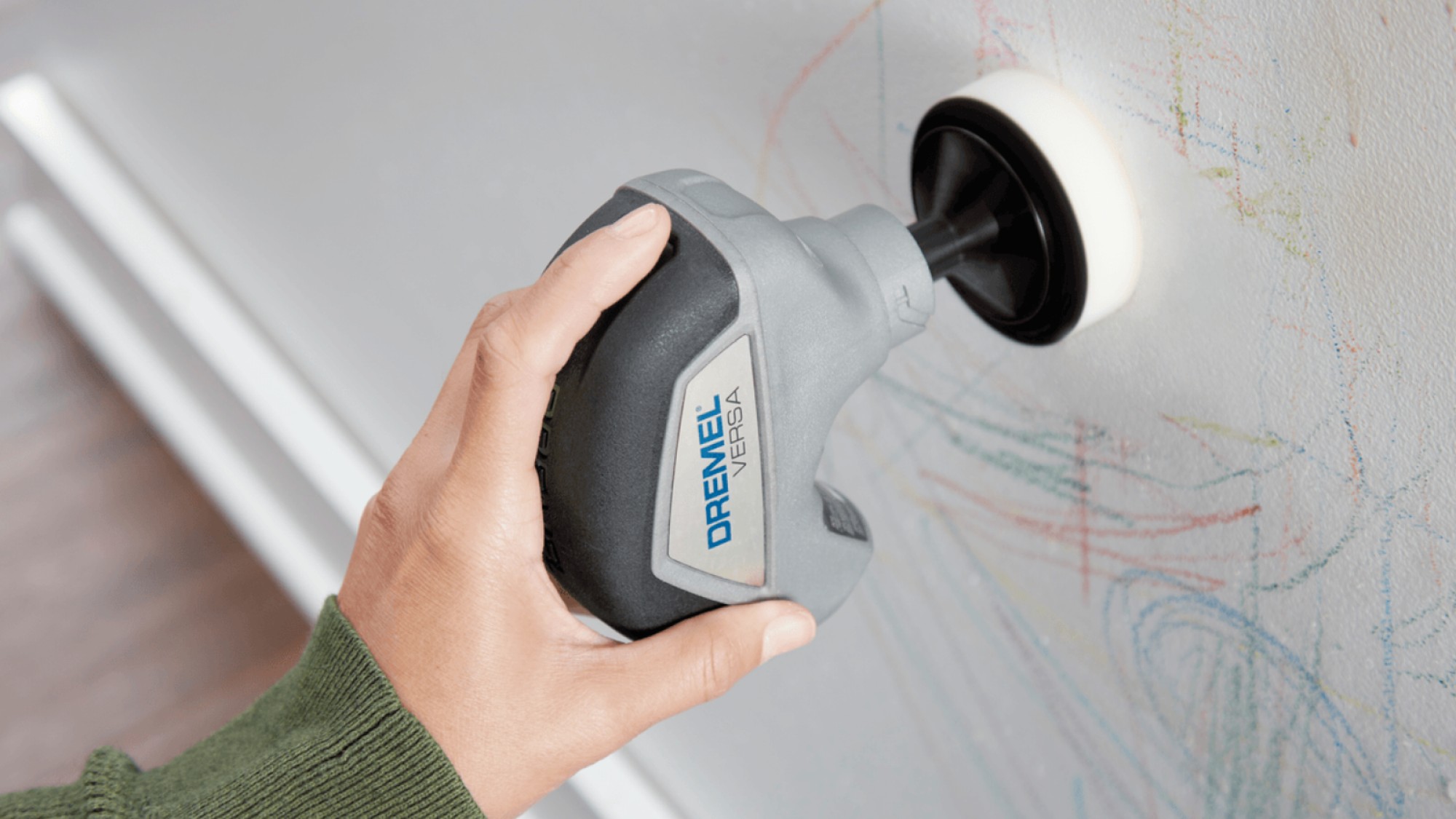 The Dremel Versa cleaning children's scribbles off a wall.