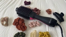 Revlon One-Step on a cream background surrounded by hair clips and scrunchies