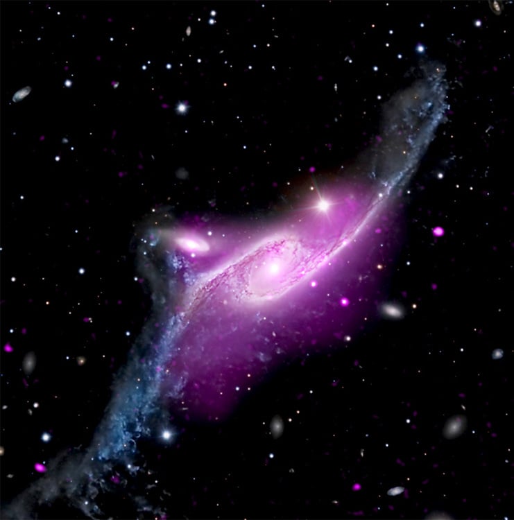 An image taken of space shows a purple and white spiral galaxy.