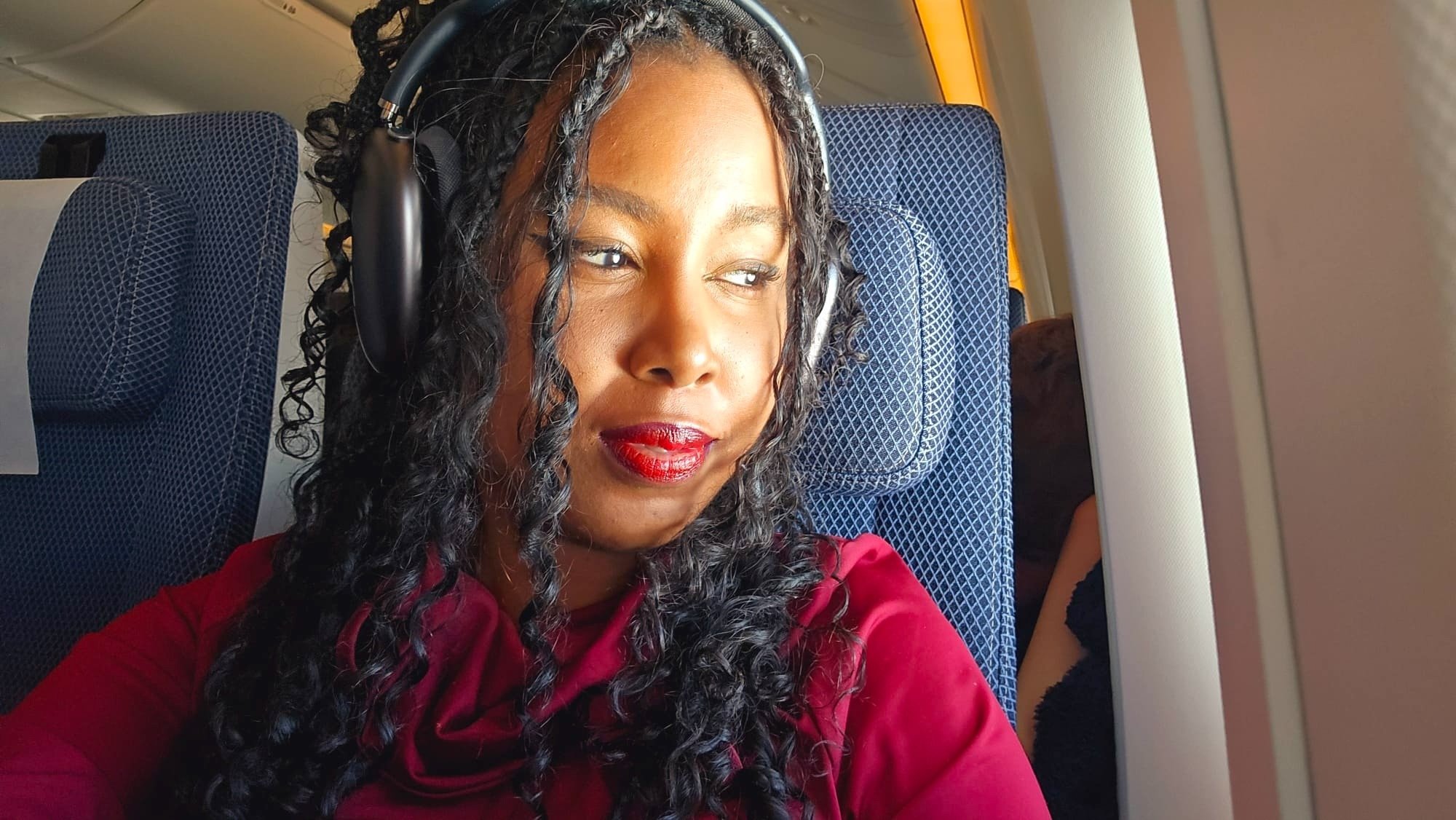 Woman wearing Apple AirPods Max on a plane