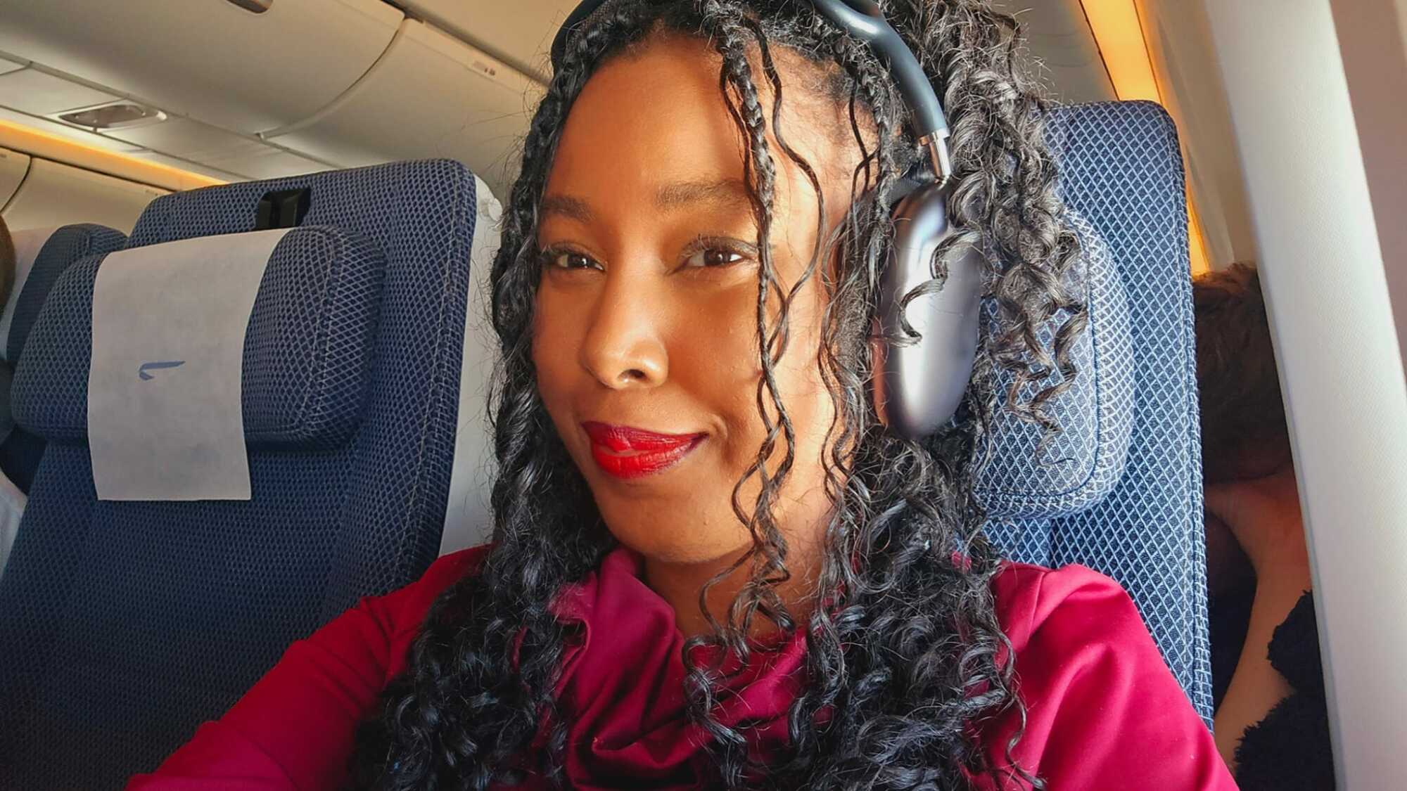 Woman wearing Apple AirPods Max on a plane