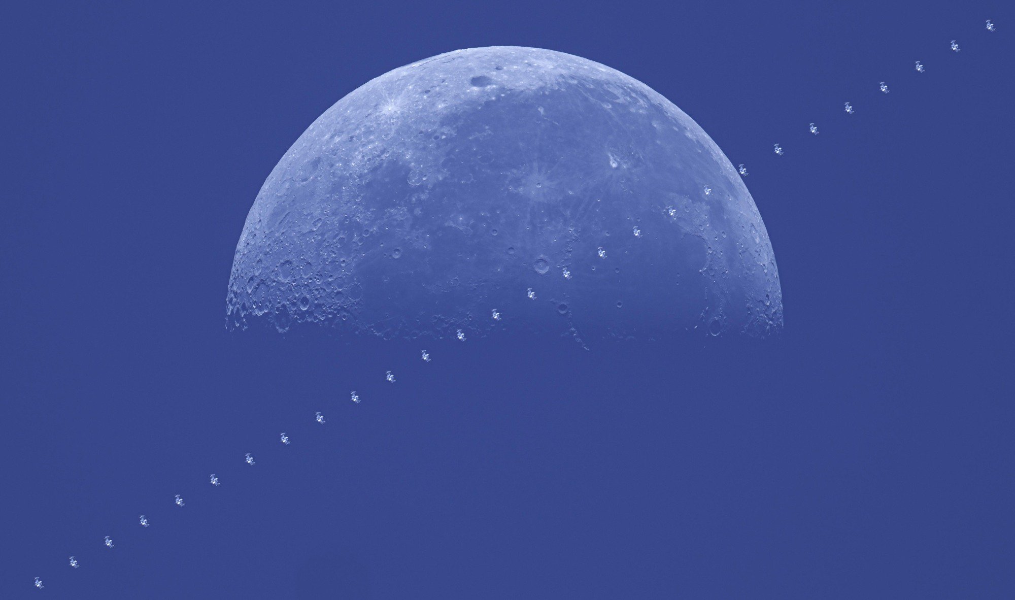 This image shows the International Space Station (ISS) transiting the 51 per cent-illuminated Moon.