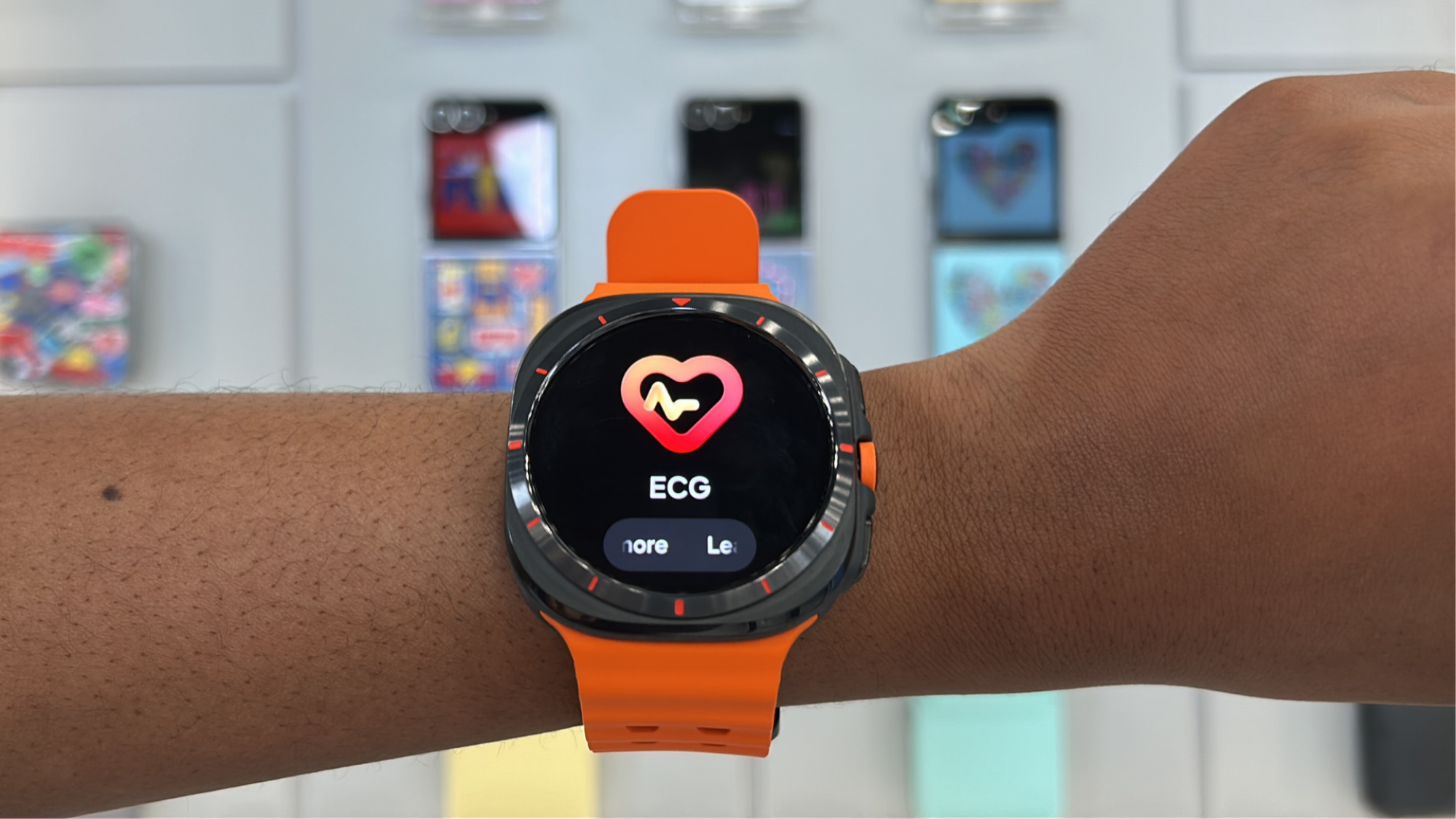 A person wearing a Samsung Galaxy Ultra Watch with the face showing and ECG measurement.