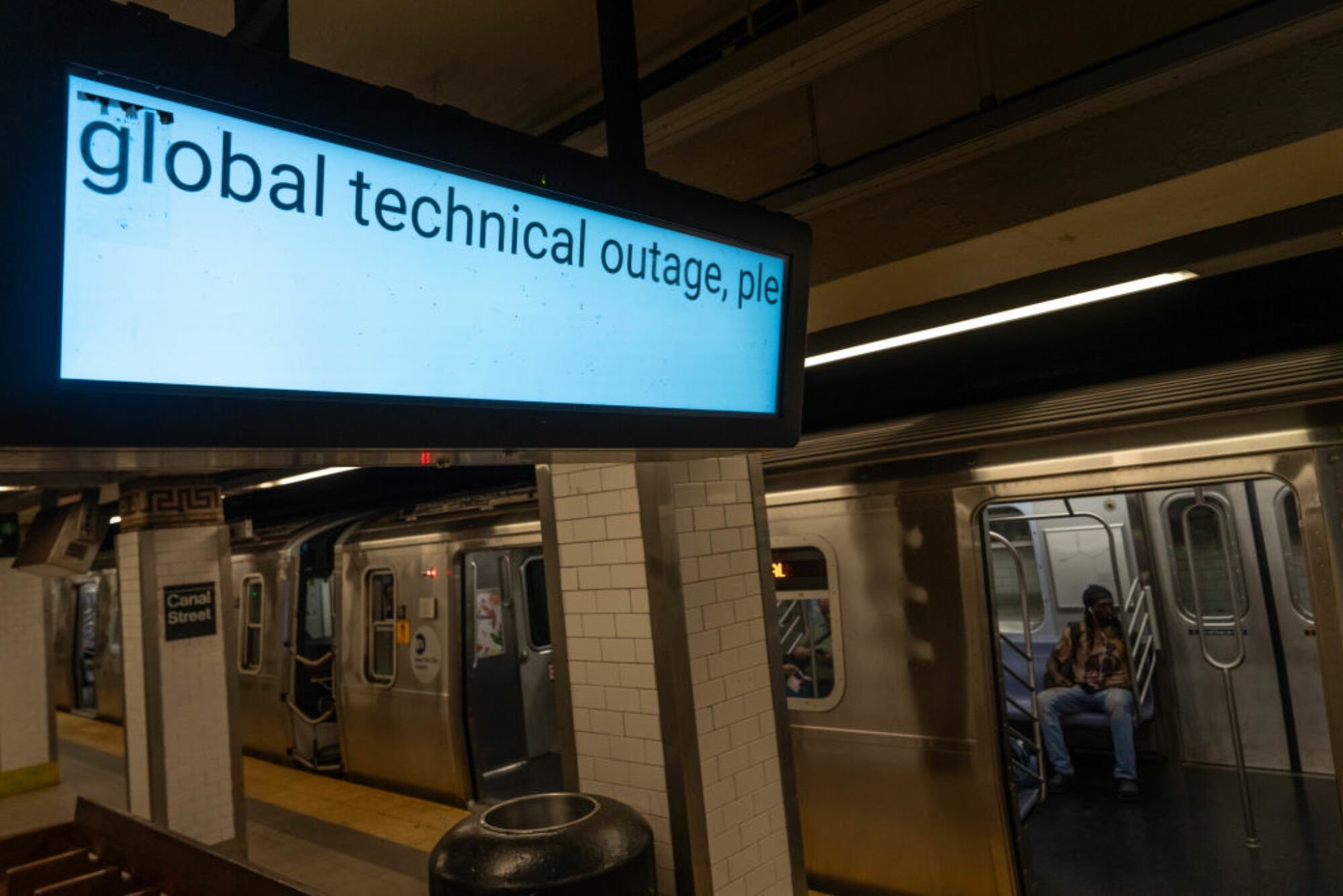 An information screen informs travellers that train information is not running due to the global technical outage at Canal Street subway station on July 19, 2024 in New York City.